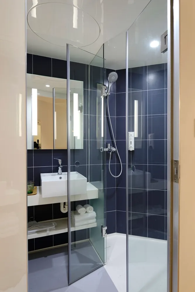 Glass shower and wall mounted sink in a bathroom