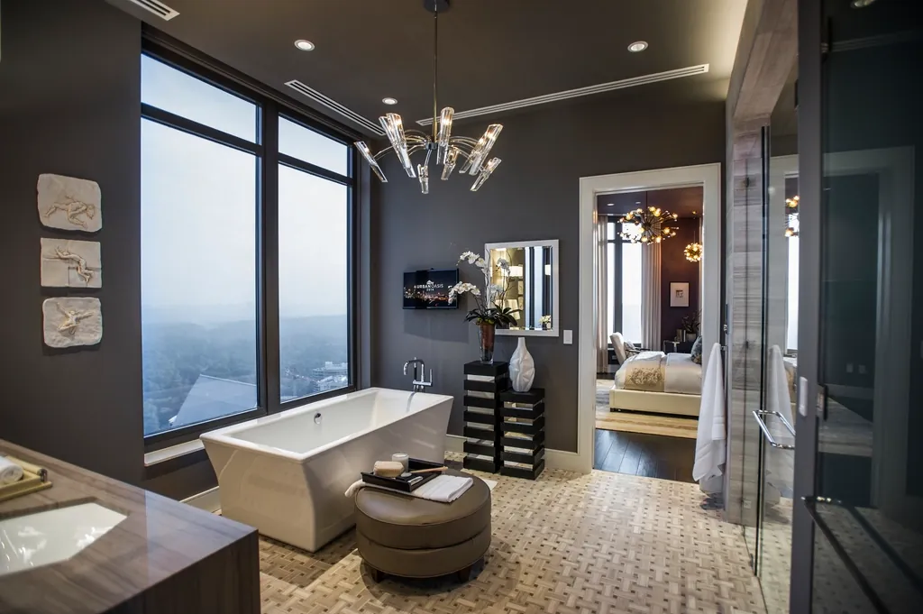 Bathroom with a freestanding tub and tall windows