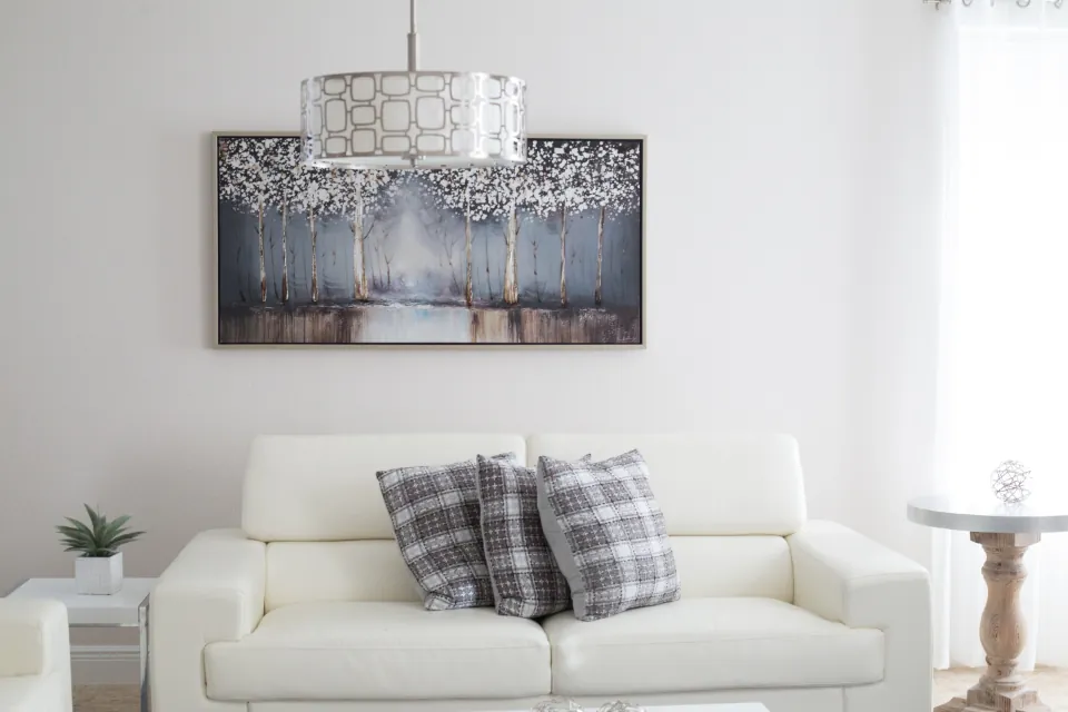White sofa with plaid cushions in a bright living room
