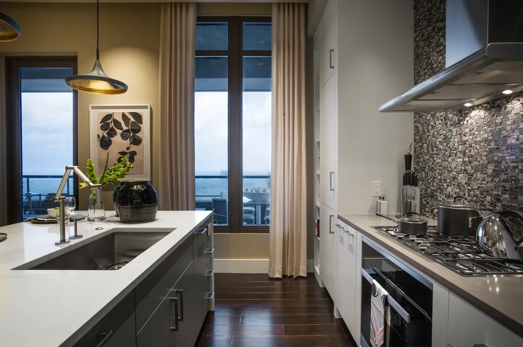Kitchen with a long counter and a tall window